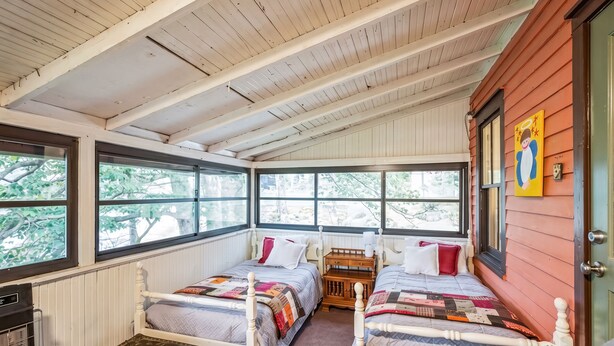 A room with two beds, a radiator, a suitcase, and a window with a view of trees. - Vintage Saluda Escape Near Waterfalls (Saluda)