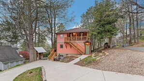 A two-story house with a balcony, a driveway, and a small shed. - Vintage Saluda Escape Near Waterfalls (Saluda)