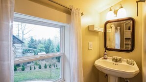 A bathroom with a window, a sink, and a mirror. - Vintage Saluda Escape Near Waterfalls (Saluda)