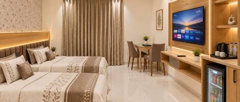 A hotel room with a bed, a desk, a television, and a mini-fridge.