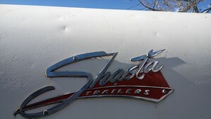 A logo with the text 'Shasta Trailers' on a vehicle. - Vintage Shasta Camper with Relaxing Fire Pit Escape on Geyserville, California (Geyserville)