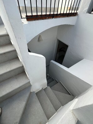 A staircase with white walls and a metal railing, leading to a landing with a door. - Perfect 5-bedroom house with AC in lovely Xàbia (Xàbia)