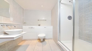 A modern bathroom with a white sink, toilet, and shower. - Student Only Gallery Apartments (Glasgow)