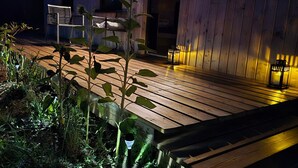 A wooden deck with a bench, a small table, and a potted plant. - “La Tiny de Miss Purple” with Terrace and Private Garden (Chantelle)