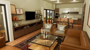 Een moderne woonkamer met een bank, fauteuils, een salontafel en een televisie. Er is een eethoek met een tafel en stoelen, en een keuken met kasten en apparatuur.