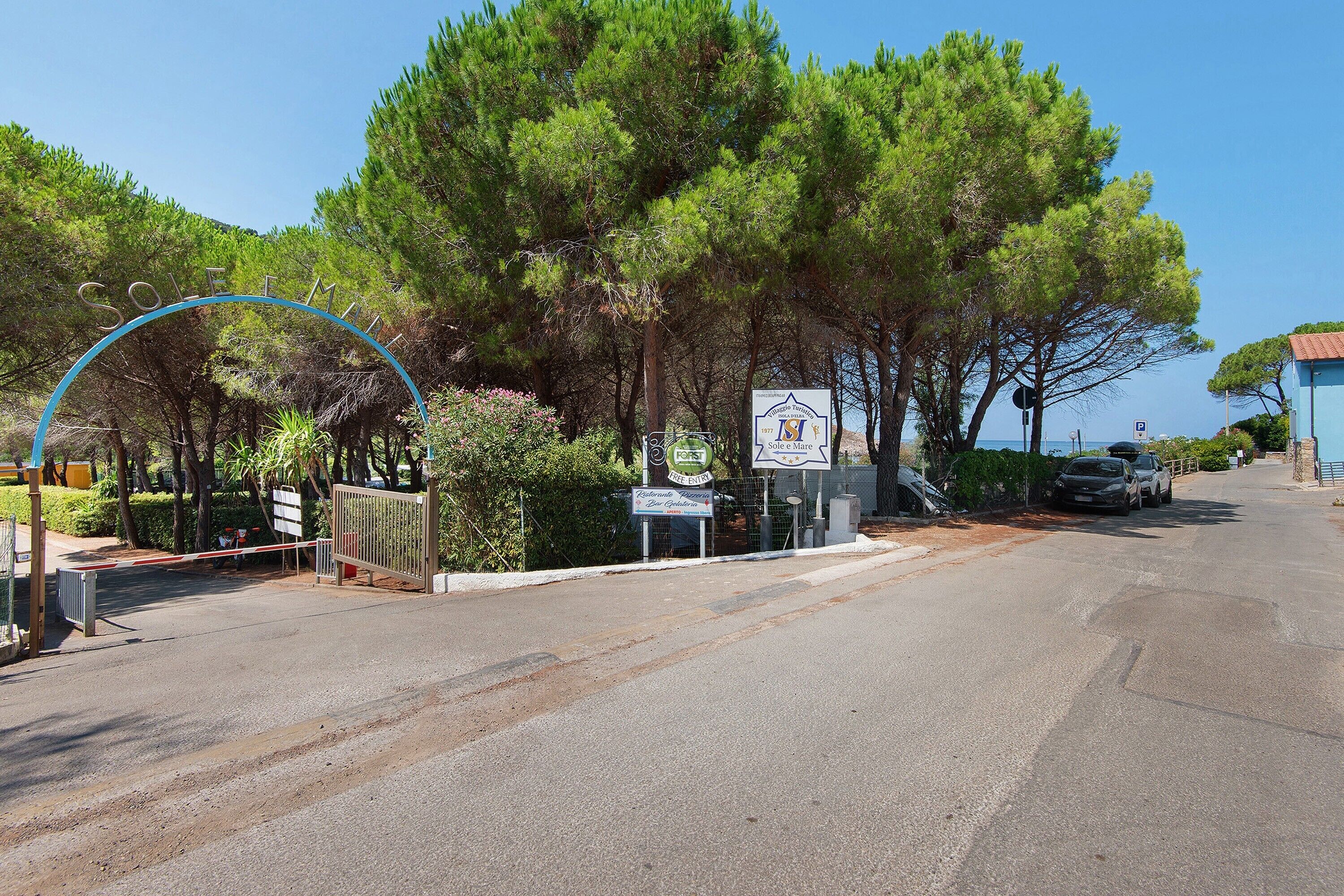 A road leading to a property with a sign indicating a restaurant and bar.