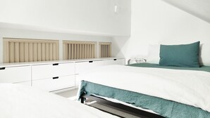 A bedroom with a bed, a dresser, and a radiator. - Ski-In Ski-Out Retreat in the Heart of Mtn Village (Telluride)