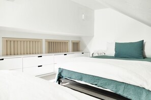 A bedroom with a bed, a dresser, and a radiator. - Ski-In Ski-Out Retreat in the Heart of Mtn Village (Telluride)