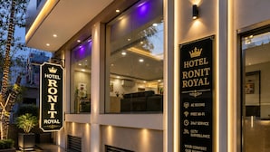 A hotel entrance with a sign indicating 'Hotel Ront Royal' and amenities such as AC rooms, free Wi-Fi, 24x7 service, and CCTV surveillance. - HOTEL RONIT ROYAL - DELHI AIRPORT  (New Delhi)