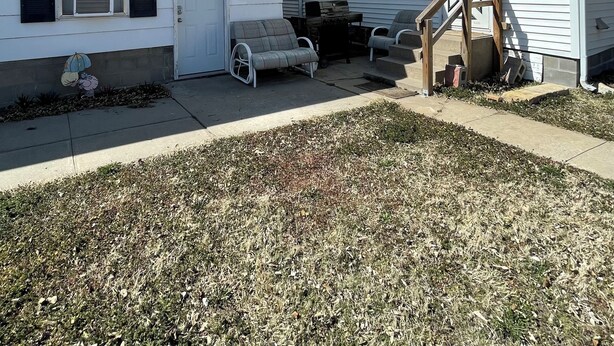 A residential area with two houses, one with a porch and a grill, and another with a chimney. - Cozy 1-bedroom apartment in marvelous Glen Elder with AC (Glen Elder)