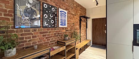 Un interior moderno con pared de ladrillo, estantes de madera y una puerta.