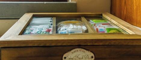 A wooden box with a glass front, containing various items including a plastic bag and papers.