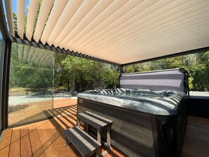 A hot tub under a canopy on a wooden deck with a view of trees. - Welcome to Le Jardin des Cambrettes, a 2-hectare private estate at the gate (Lattes)