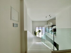 A modern interior with a staircase, glass railings, and pendant lighting. - Welcome to Le Jardin des Cambrettes, a 2-hectare private estate at the gate (Lattes)