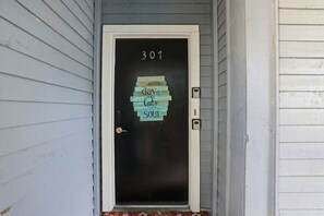 A door with a number '301' and a sign that reads 'day at the lake relaxes the soul.' - Waterfront Condo 10 Min from Margaritaville! (Montgomery)