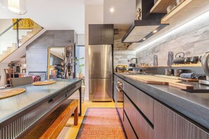A modern kitchen with a stainless steel refrigerator, wooden countertops, and a built-in oven. - Hikari Haven Richmonds Creative Spirit near Cafs (Richmond)