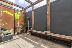 A wooden deck with a bench and potted plants. - Hikari Haven Richmonds Creative Spirit near Cafs (Richmond)