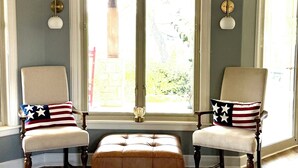 A room with two armchairs, a wooden floor, and a window with a view of greenery. - Hill Country Estate on 11 Acres near Dripping Springs and Wimberley (Wimberley)