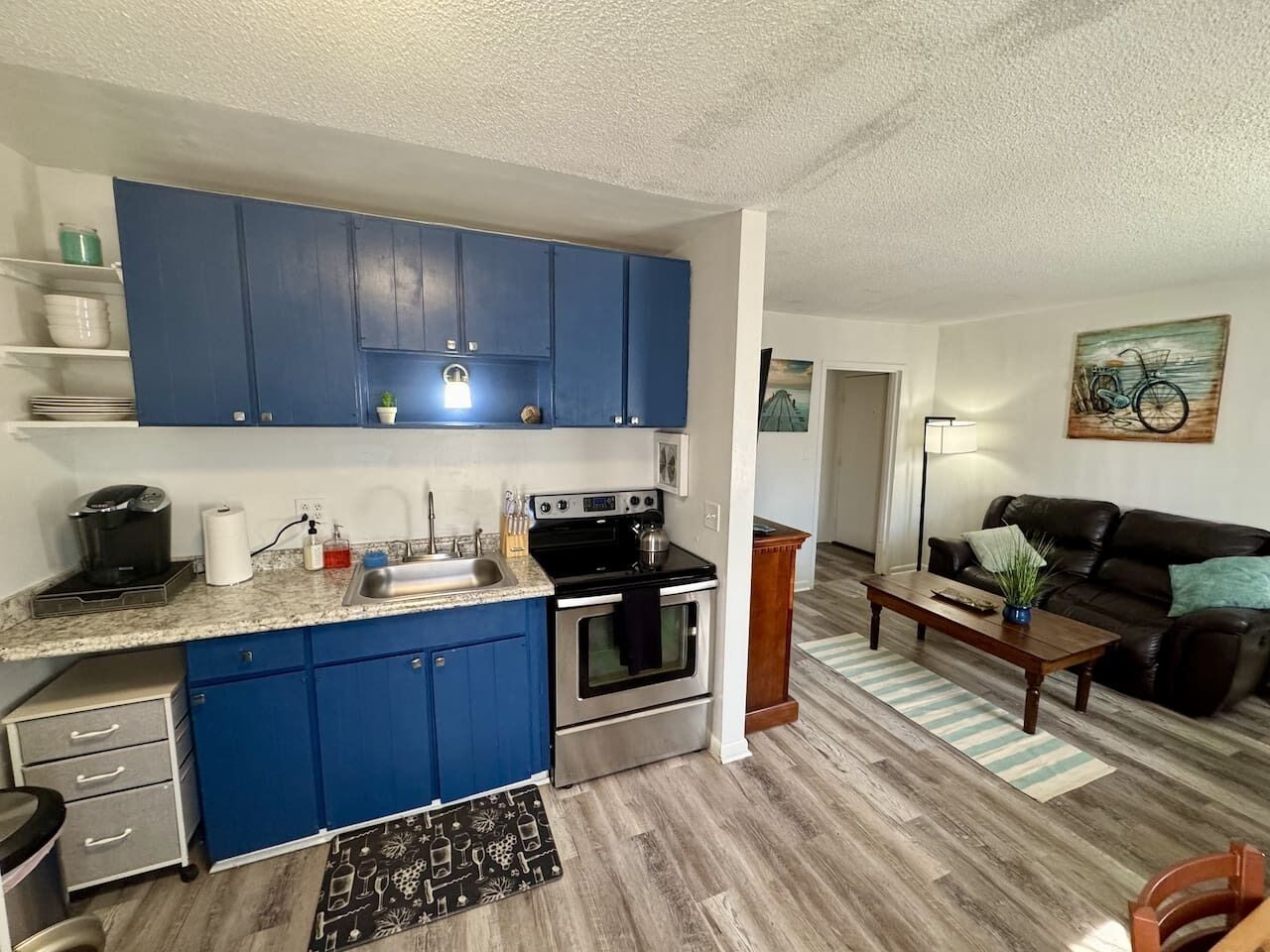 A compact living space with a kitchenette, a dining area, and a seating area.