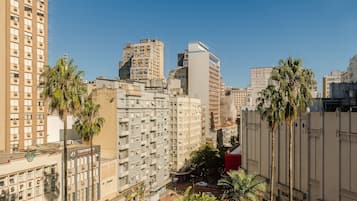 A high-rise building with multiple floors, a business hotel, and palm trees.