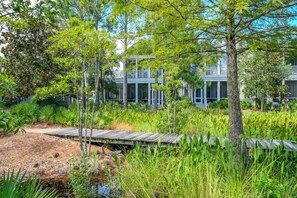 A two-story building with a covered porch and a wooden deck. - The Summer Sweet Escape by Stay on 30a (Santa Rosa Beach)
