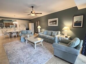 A living room with a sofa set, coffee table, and lamps. - Charming 2BR Condo w/ Hammock Beach Resort Access (Palm Coast)