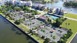 Vue aérienne d’un hôtel doté d’un port de plaisance, de courts de tennis et d’une piscine.