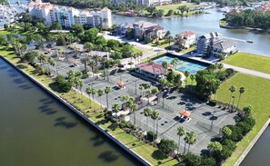 An aerial view of a hotel with a marina, tennis courts, and a swimming pool. - Ocean & Golf View Condo w/ Pools & Resort Access (Palm Coast)