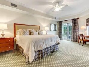 A hotel room with a bed, a desk, and a view of the outdoors. - Pool-View 2BR Condo w/ Hammock Beach Resort Access (Palm Coast)