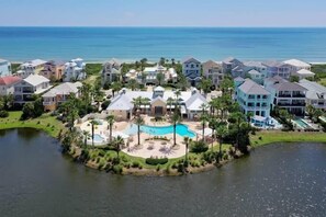 A coastal resort with multiple buildings, a central pool area, and a body of water. - Oceanview Condo w/ Balcony, Pools & Resort Access (Palm Coast)