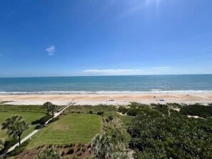 A coastal landscape with a beach, grassy areas, and trees. - Oceanside 3BR Condo w/ Hammock Beach Resort Access (Palm Coast)