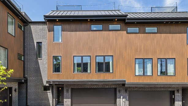 A modern two-story building with a brick facade and large windows. - NEW Home with Luxury Wet Room & Rooftop Hot Tub 8 to Broadway (Nashville)