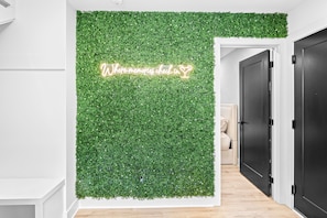 A hallway with a green wall and a neon sign that reads 'Where memories check in.' - NEW Home with Luxury Wet Room & Rooftop Hot Tub 8 to Broadway (Nashville)
