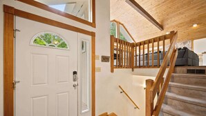 Una escalera con barandillas de madera que lleva a una sala de estar con un sofá.