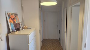 A hallway with a white dresser, a mirror, and a painting on the wall. - Bright and spacious 1 bedroom flat near Warren Street. Perfect to explore London (London)