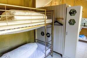 A bunk bed with a lower bunk, a wardrobe with a mirror, and a shelf with a hanging garment.