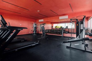 A gym with treadmills, weight machines, and dumbbells. - Luxury loft in the heart of Playa del Carmen Stunning Rooftop Pool and Jacuzzi (Playa del Carmen)