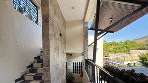 A hotel interior with a staircase, a balcony with a view, and a wooden floor. - Hotel Frailes (Arriaga)