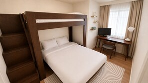 Ett hotellrum med en våningssäng, ett skrivbord med en dator och en stol.
