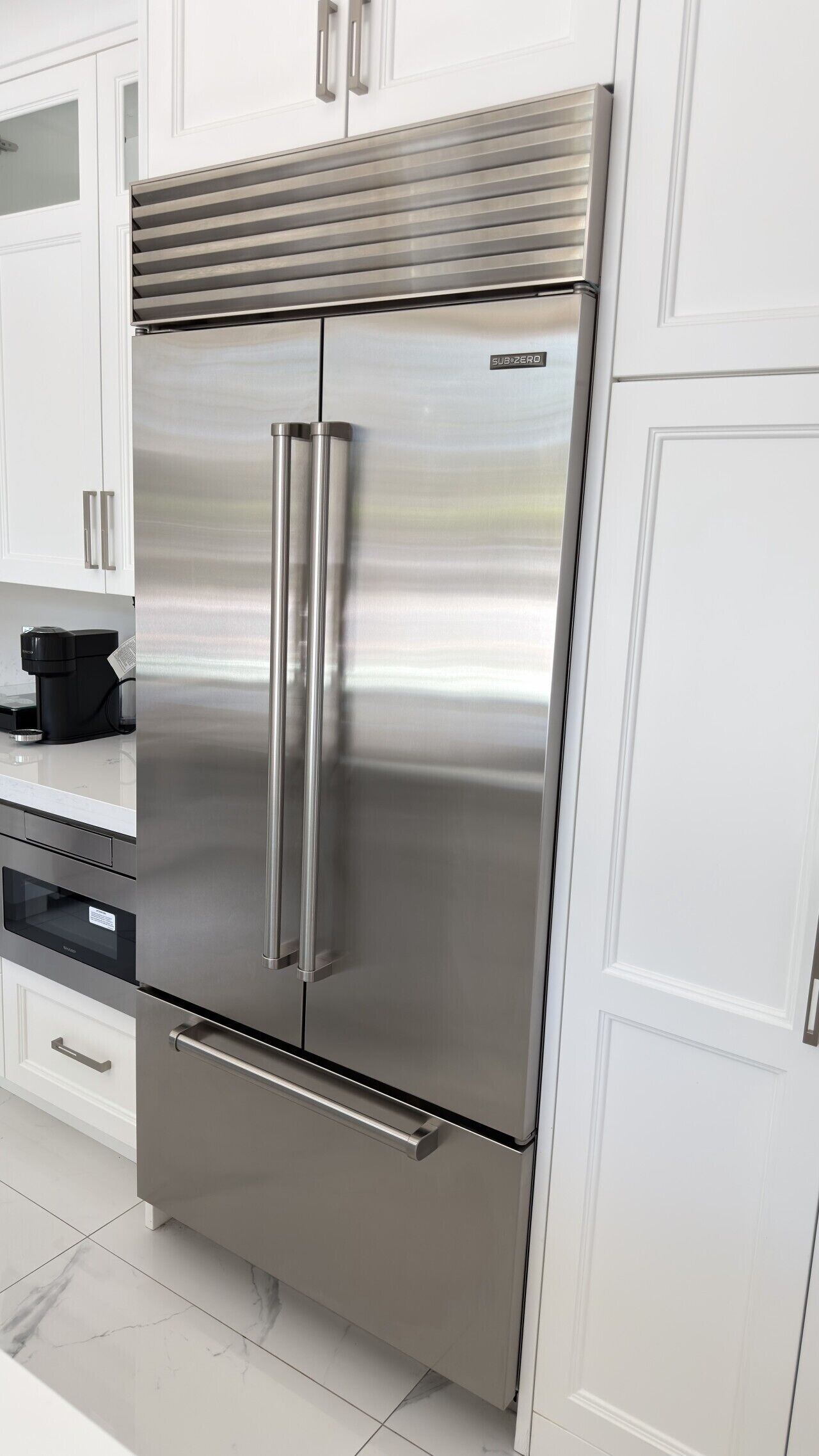 A stainless steel refrigerator with a double door, a built-in ice maker, and a water dispenser.