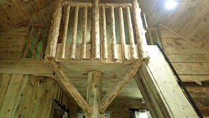 A rustic wooden ceiling with exposed beams and a central wooden structure. - Tiny Cabin with Fire Pit & Covered Porch Retreat in Salem, Missouri (Salem)