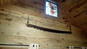 A wooden interior with a window, curtains, and a stained glass window. - Tiny Cabin with Fire Pit & Covered Porch Retreat in Salem, Missouri (Salem)