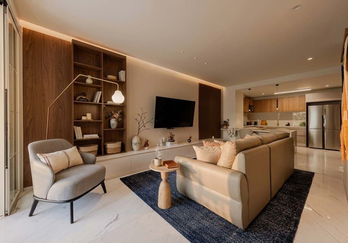 A modern living room with a sofa, armchair, and a coffee table.