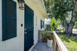 A house with a dark blue door, a white exterior, and a number '1326' on the wall. - Coastal Cocoanut Cottage ~ Whitaker Bayou~Bay (Sarasota)