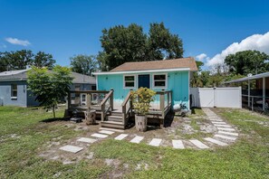 A small, single-story house with a porch and a small deck. - Coastal Cocoanut Cottage ~ Whitaker Bayou~Bay (Sarasota)