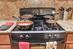 A kitchen with a stove, pots, and a red towel. - 2UNITS!20+ Guests!King Bed!2 Pools!Free Parking (Houston)