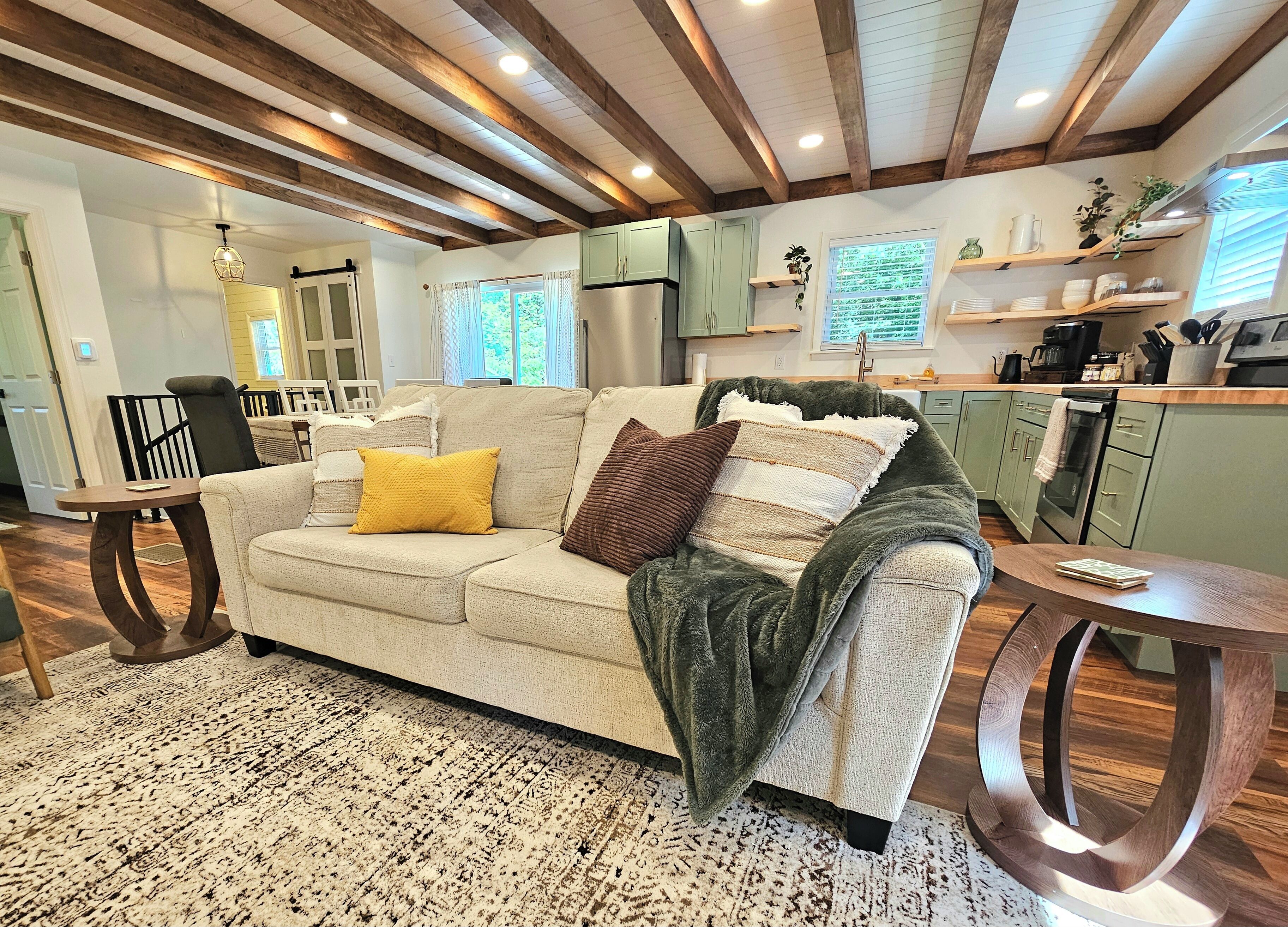 A cozy living room with a sofa, a coffee table, and a patterned rug.