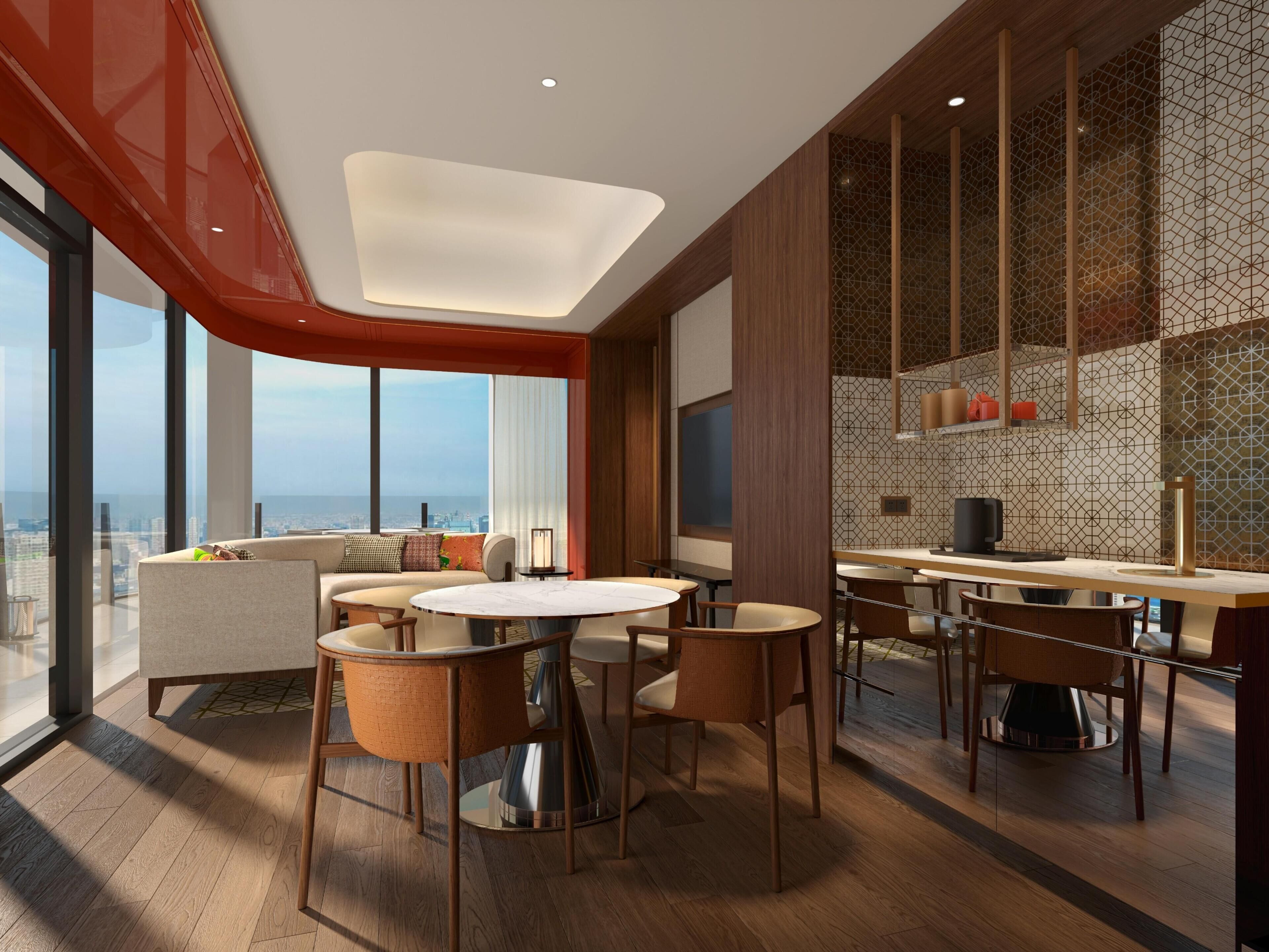 A modern hotel room with a dining area, large windows, and a city view.