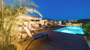 A rooftop pool area with lounge chairs and a view of a hillside. - Departamento una recámara en Santa Cruz (Bahía de Santa Cruz Huatulco)