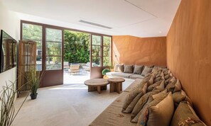 A modern living room with a large window, a sofa, and a coffee table. - EXPERIENCE THE ELEGANCE OF THE FRENCH RIVIERA IN THIS EXCEPTIONAL 300 M² VILLA (Cannes)